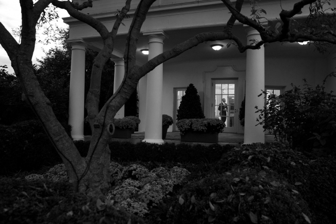 President Barack Obama walks through the Oval Office as seen from the Rose Garden of the White House, Nov. 4, 2015. (Official White House Photo by Pete Souza)